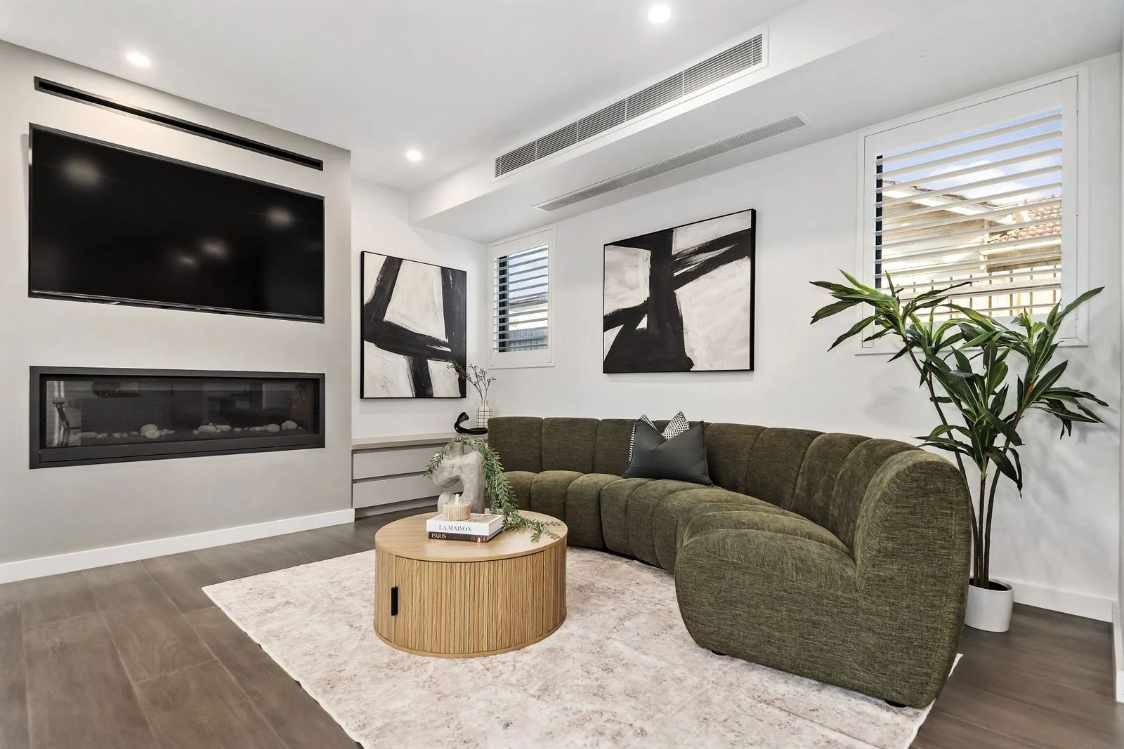 Living room with a linear fireplace in a Zentos Constructions home